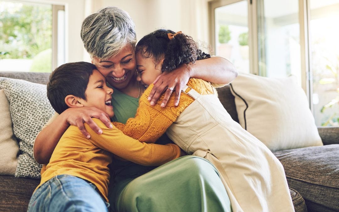 A grandmother plays with her grandchildren.