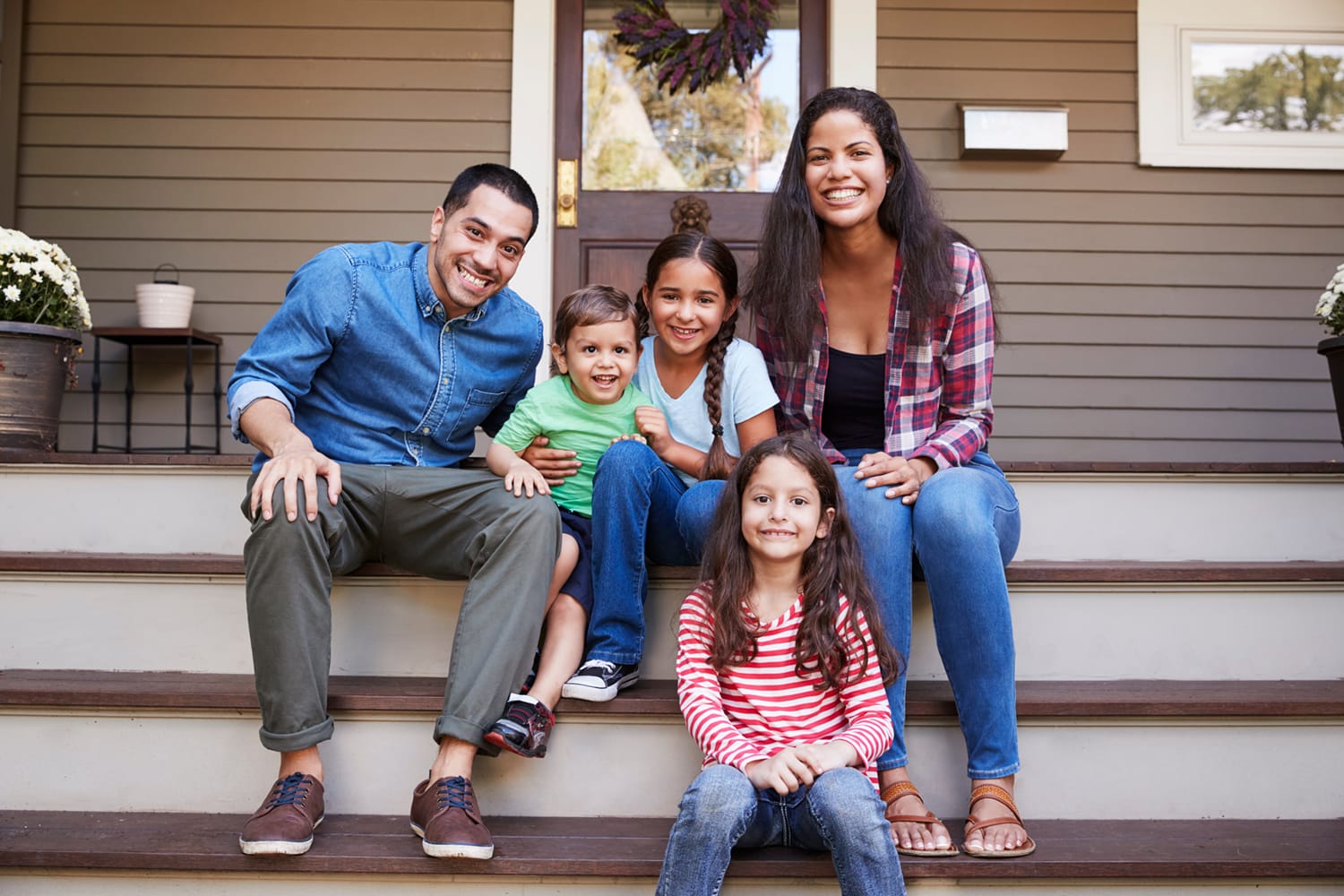 A family enjoys fresh air on their front porch.